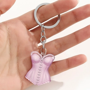 Close-up of pink acrylic corset keychain with lace details and silver metal ring
