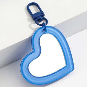 Detail of blue heart-shaped portable mirror charm with matching lobster clasp and mirror