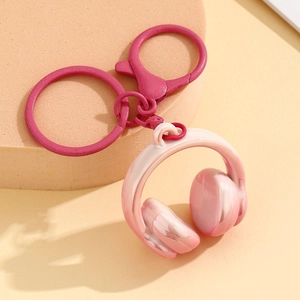 Stereo headphone keychain in pink gradient with a metallic ring and lobster clasp