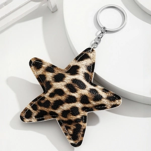 Star-shaped leopard print keychain with silver metal ring on a white minimalist background