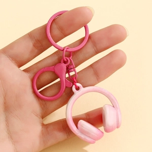 Close-up of pink headphone keychain with gradient pendant and metal lobster clasp