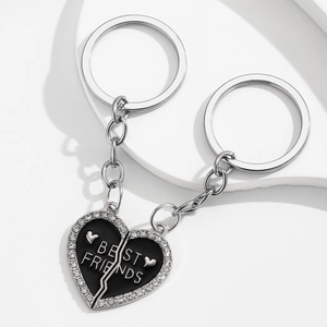 Detailed macro view of heart-shaped Best Friends keychains with black enamel and rhinestones