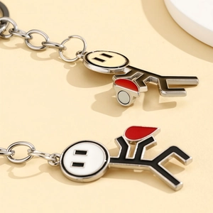 Detail view of magnetic stickman couple keychains showing a heart-shaped attraction feature