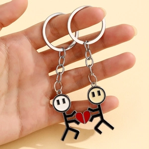 Detail of magnetic matchman couple keychain with split heart design in alloy metal