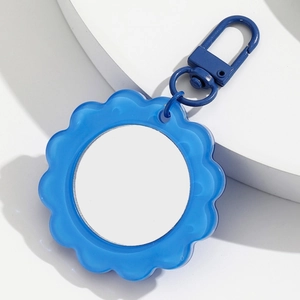 Blue sunflower keychain with a compact mirror featuring a translucent petal design