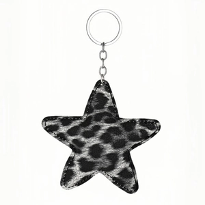 Star shaped keychain featuring black and white leopard print leather with silver metal ring