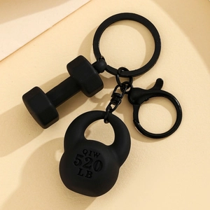 Detail shot of a matte black kettlebell and dumbbell keychain with a durable metal hook