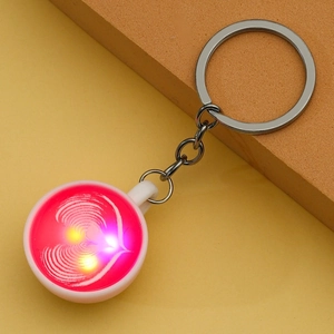 Glow-in-the-dark miniature coffee cup keychain with heart latte art and LED light