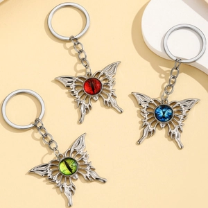 Set of three butterfly keychains in red blue and green with a retro hip-hop devil eye design