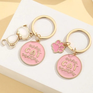 Golden alloy cat keychain with pink enamel cat paw and Every Cat Matters charm