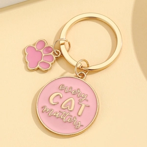 Golden cat keychain with pink enamel every cat matters charm and small paw pendant