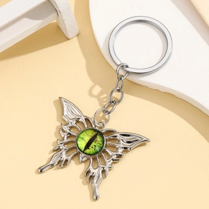Gothic butterfly keychain with silver metal wings and a green evil eye centerpiece