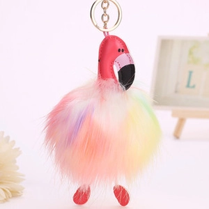Detailed close-up of rainbow faux fur flamingo keychain with gold metal ring and pink leather head