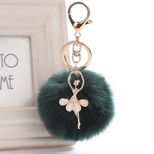 Detail of ballerina keychain with dark green faux fur pompom and sparkling crystal charms