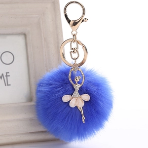 Detail of royal blue faux fur ball and gold ballerina pendant with rhinestones