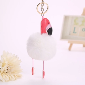 Détail du porte-clés flamant rose avec pompon blanc et anneau en métal doré brillant