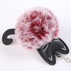 Cute cartoon cat keychain with reddish brown fluffy faux fur pompom and black leather accents