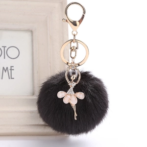 Macro detail of ballerina bag charm with black faux fur pompom and rhinestone crystals