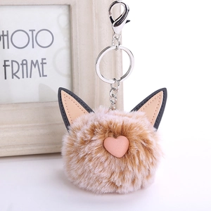 Close-up of fluffy faux rabbit fur cat ear keychain with pink heart and silver lobster clasp