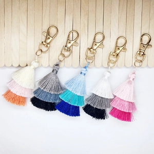 Set of five colorful layered cotton tassel keychains with golden lobster clasps for bags
