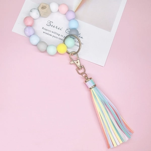 Porte-clés en perles de silicone macaron avec perle en bois oeil et breloque pompon coloré