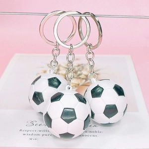 Set of three classic black and white football keychains with silver metal rings