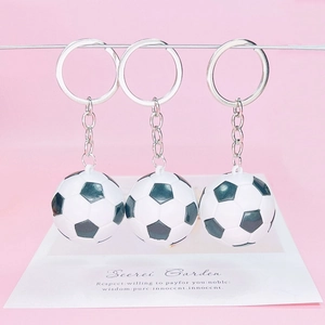 Three-piece football keychain set with classic black and white soccer ball pendants