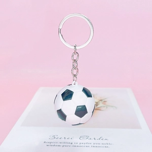 Detailed view of the mini football keychain with black and white classic sports pattern