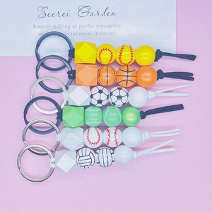 Detail view of 6-style handmade sports beaded keychains with soccer and baseball wood beads