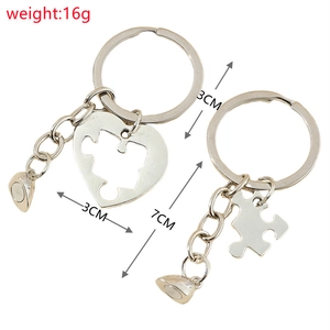 Detailed view of silver heart puzzle keychain with magnetic charm and size specifications