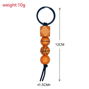 Detail of basketball themed keychain with orange wooden beads and black metal ring