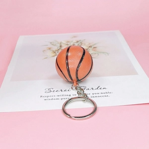 Realistic orange basketball keychain with metal ring on a decorative card back