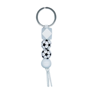 Detail of soccer themed beaded keychain with black and white football print wood beads