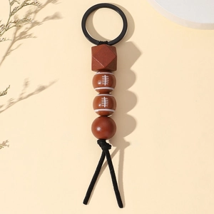 Detail of American football themed keychain with brown wooden beads and black metallic clasp