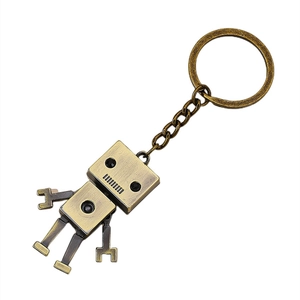 Articulated vintage bronze alloy robot keychain with rustic finish on white background