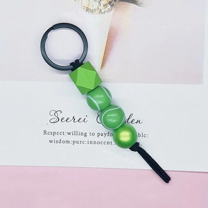 Tennis themed beaded keychain with green sports balls and matte black metal lobster clasp