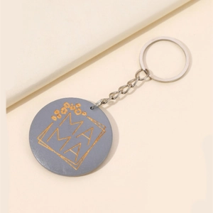 Porte-clés MAMA minimaliste avec lettrage doré et motif fleuri sur fond rond bleu-gris
