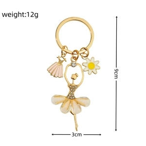 Sparkling rhinestone ballerina girl keychain with white flowers and pink dress charm