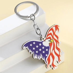Close-up of eagle keychain with American flag patterns on a white display stand