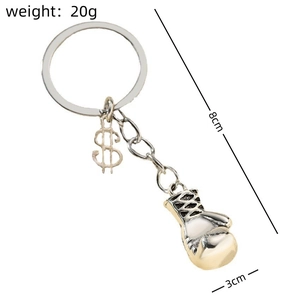 Detailed view of metal boxing glove keychain with dollar sign pendant and size specs