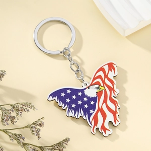 Detailed macro view of a wooden eagle keychain featuring the American flag design and metal ring