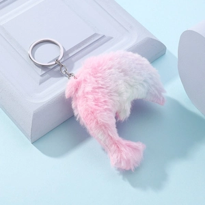 Cute pink and blue gradient plush dolphin keychain with a silver metal ring on blue background