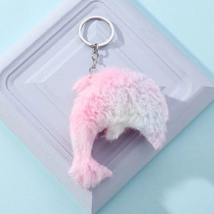 Plush dolphin keychain with gradient pink and blue fur and a silver metal ring