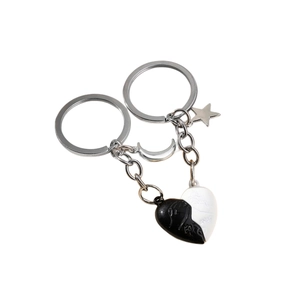 Magnetic heart couple keychain set in black and white with moon and star charms