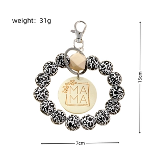 Detail showing dimension and weight of Mama keychain with leopard beads and wood tag