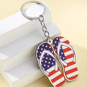 Creative American flag flip-flop keychain with polished metal ring on white stand
