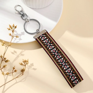 Ethnic embroidered flower keychain with geometric patterns and silver metal clasp