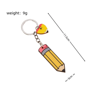 Detail showing pencil and heart charms keychain with 11.5cm length and 9g weight