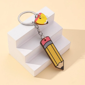 Detail view of wooden pencil-themed keychain with heart charm on white display