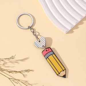 Creative pencil and heart keychain pendant gift for teachers on a soft beige background